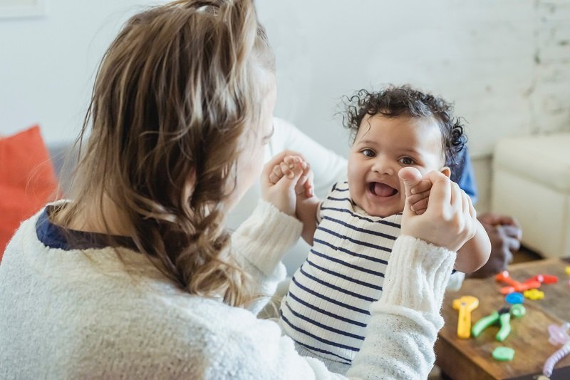 A young mom and her baby supported by Aunt Leah’s programs, symbolizing hope and stability through monthly giving.